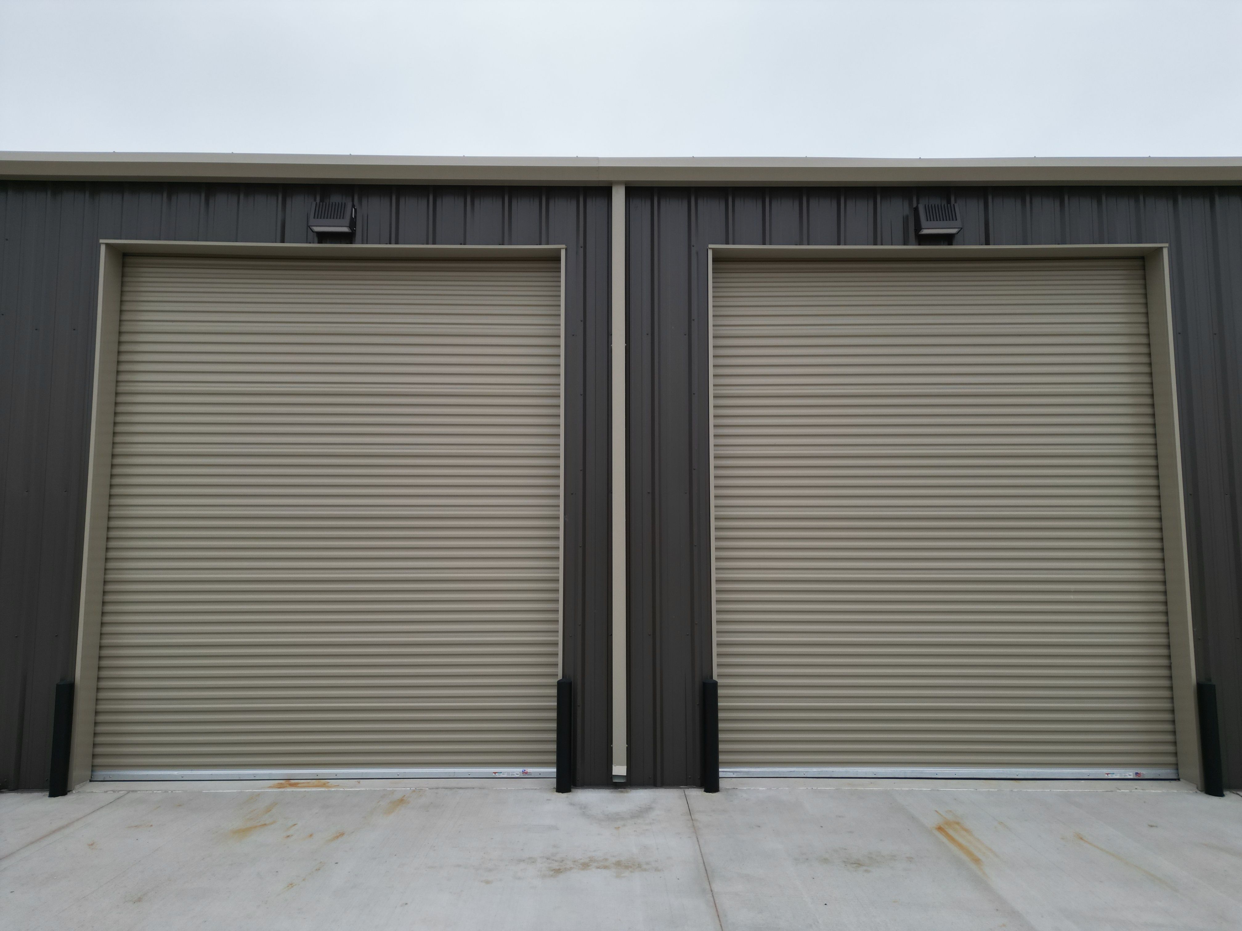 front view metal building multiple roll up doors bryan tx commercial